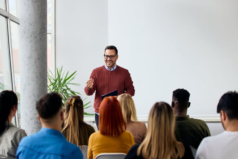 Corporate speaker delivering a motivating training session to a group of diverse employees
