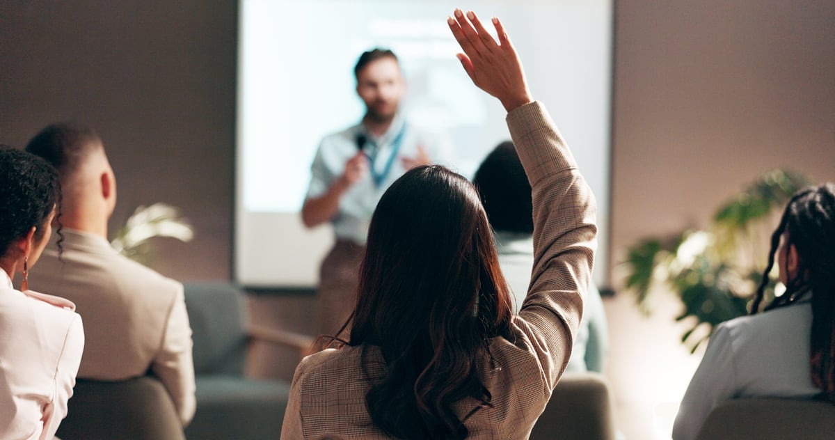Business people in seminar and convention with audience engagement and interaction for feedback