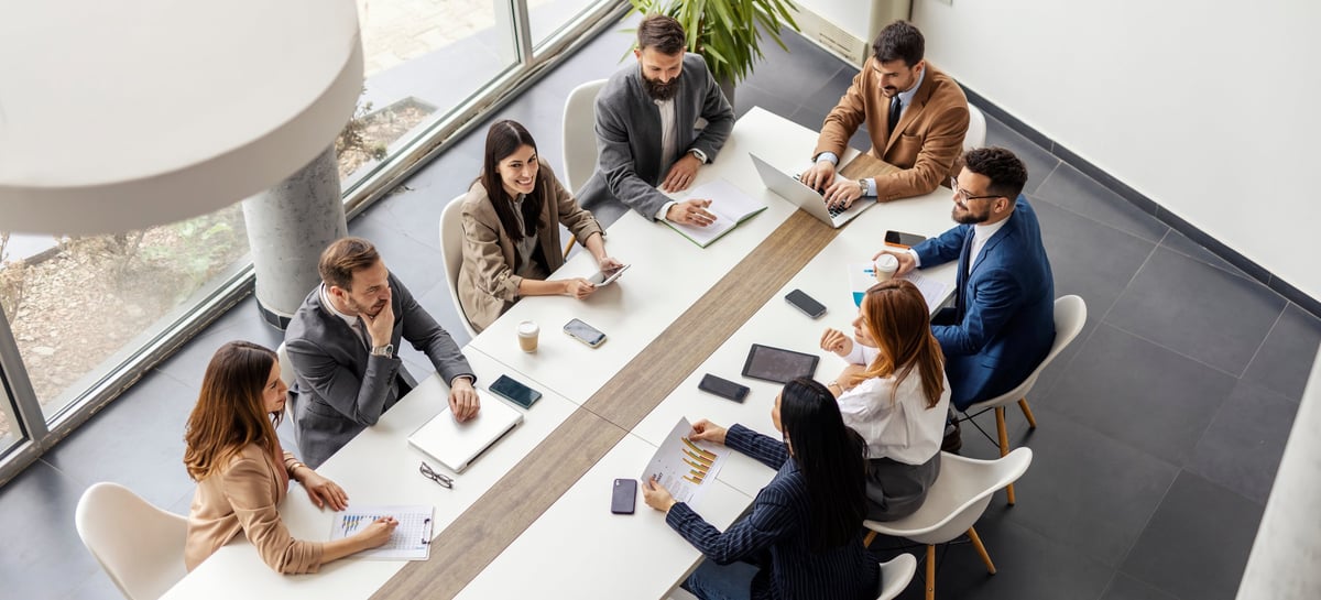 Leadership team sitting at conference table having strategy meeting